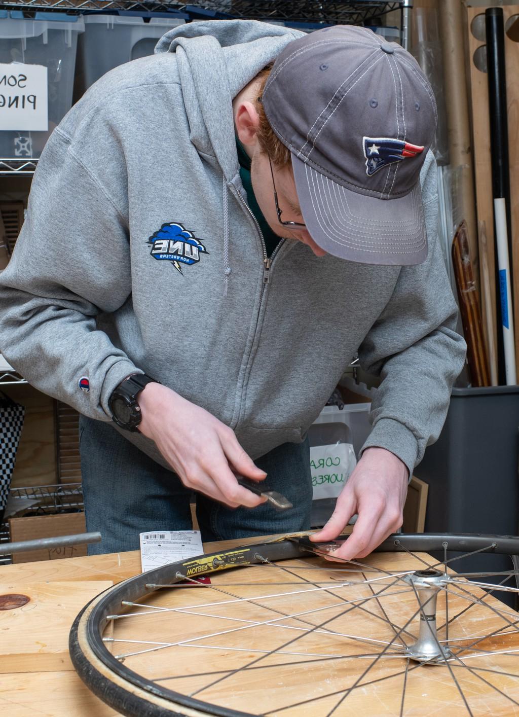 A student assembles a wheel