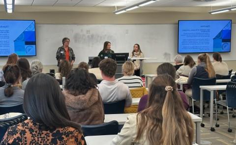 Three UNE occupational therapists give a classroom presentation